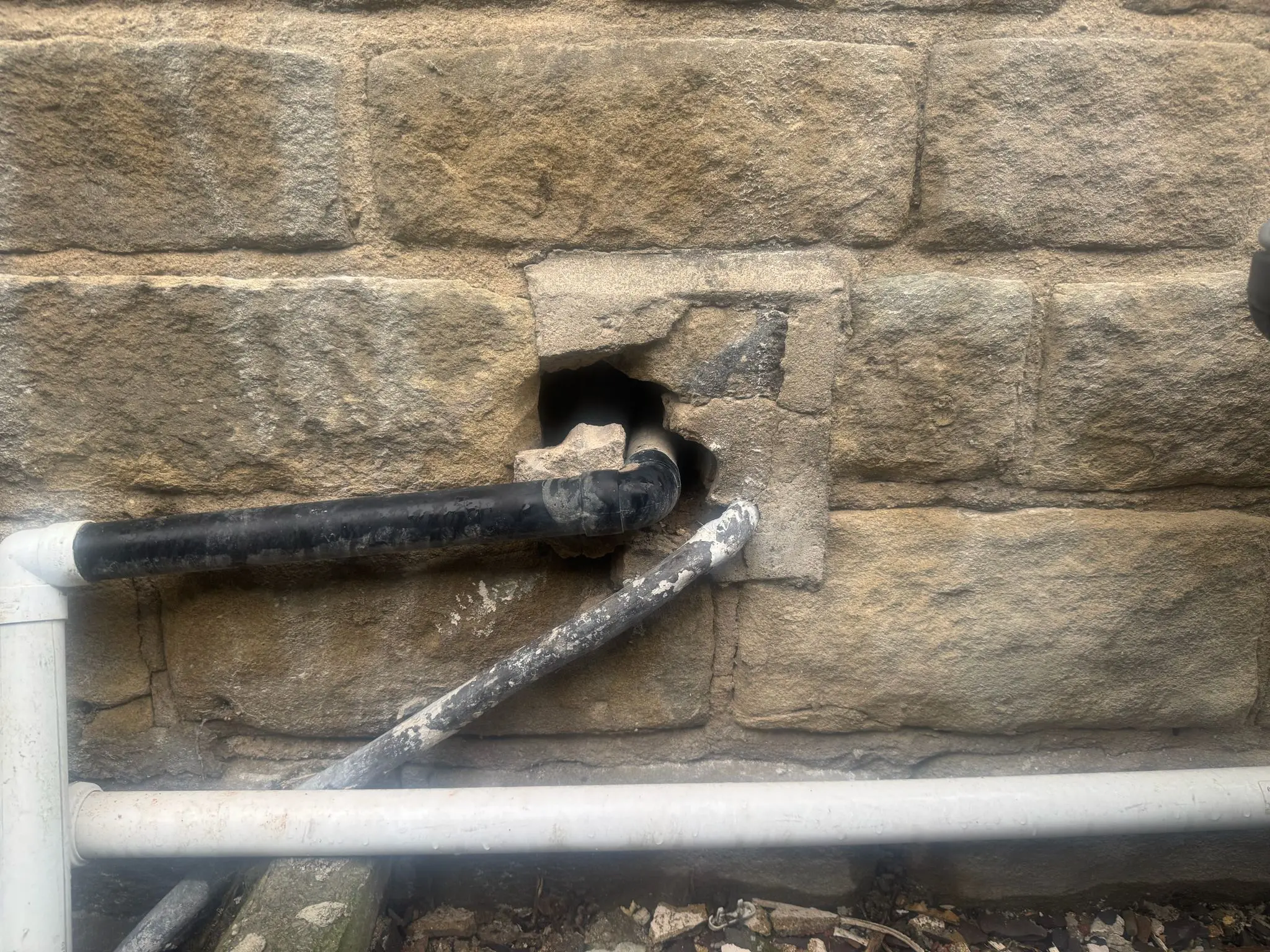Rat entry point where waste pipes pass through a building wall on a Barnsley property